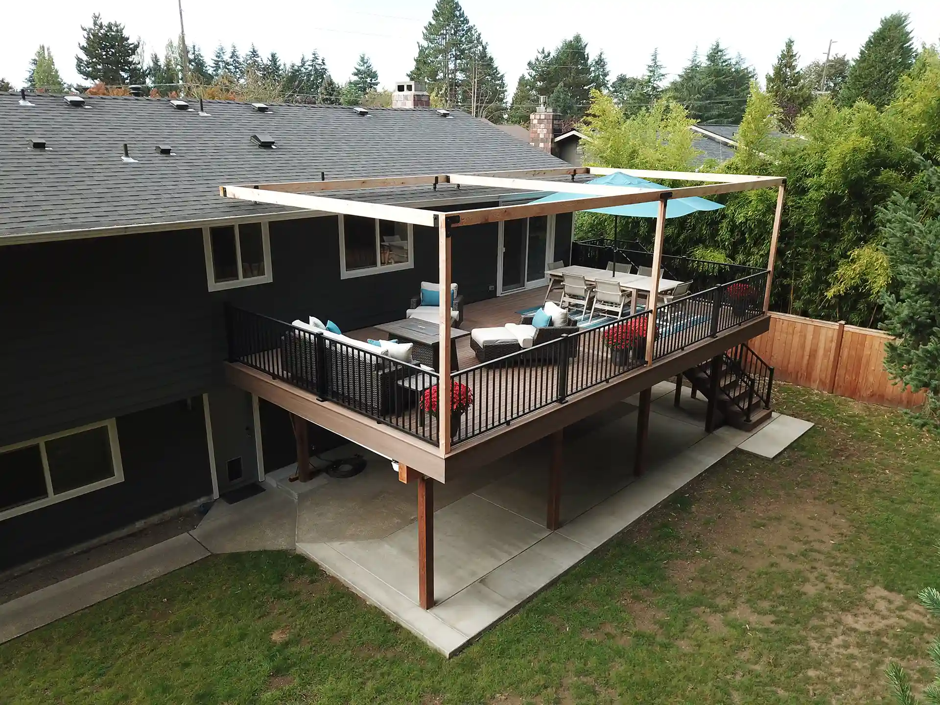 Patio beneath an elevated deck with a deck cover - Custom Patio Builders and Pavers Installation Contractors near me