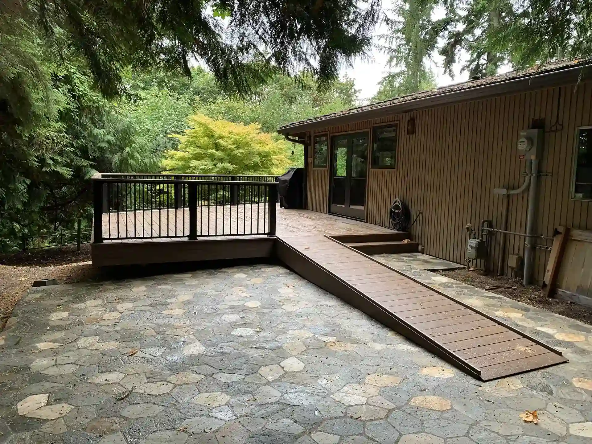 Patio and a ramp leading up to a small, raised deck - Patio Covers Builders and Stamped Patio Contractors