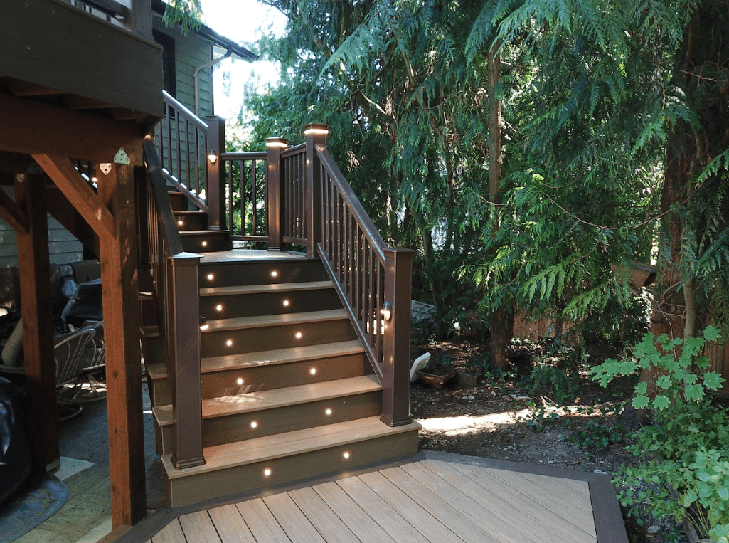 photo of TimberTech decking with deck steps, riser lights, and lighted post caps - Timbertech composite decking near me